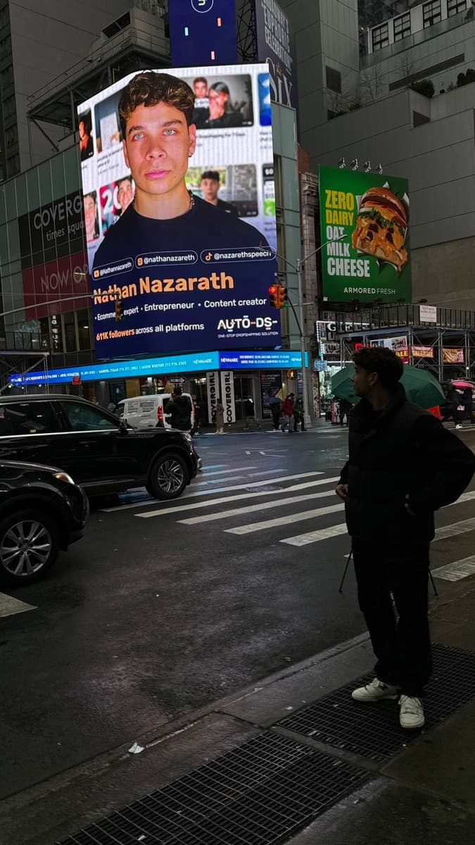 Nathan Nazareth in front of his Times Square billboard